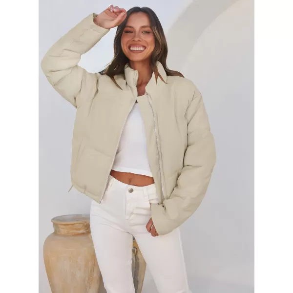 imageZESICA Womens Long Sleeve Cropped Puffer Jacket Winter Zipper Quilted Baggy Warm Short Down Coat Outwear with PocketsApricot