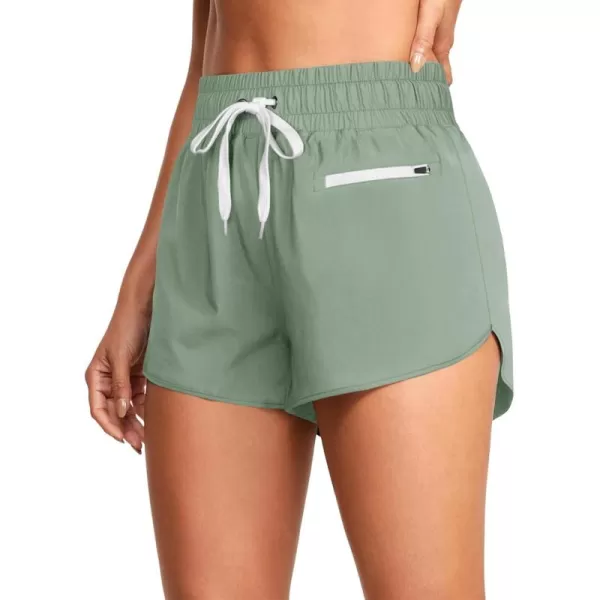 LASLULU High Waisted Dolphin Athletic Running Shorts for Women Comfy Mesh Liner Gym Workout Track Shorts Zip Pocket 25quotGreen