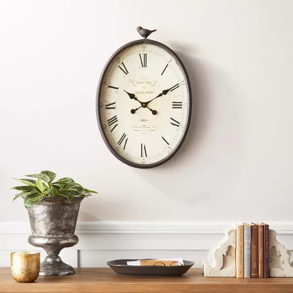 Creative CoOp Oval Metal Wall Clock with Bird