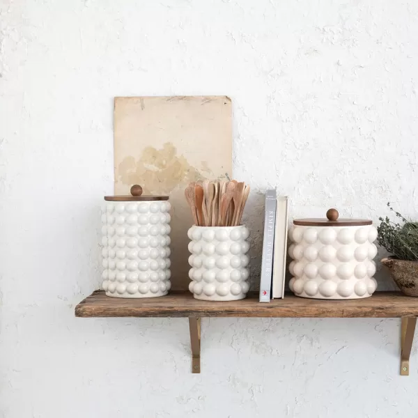 imageCreative CoOp 675 Inches Round Stoneware Raised Dots and Acacia Wood Lid White and Natural Canister