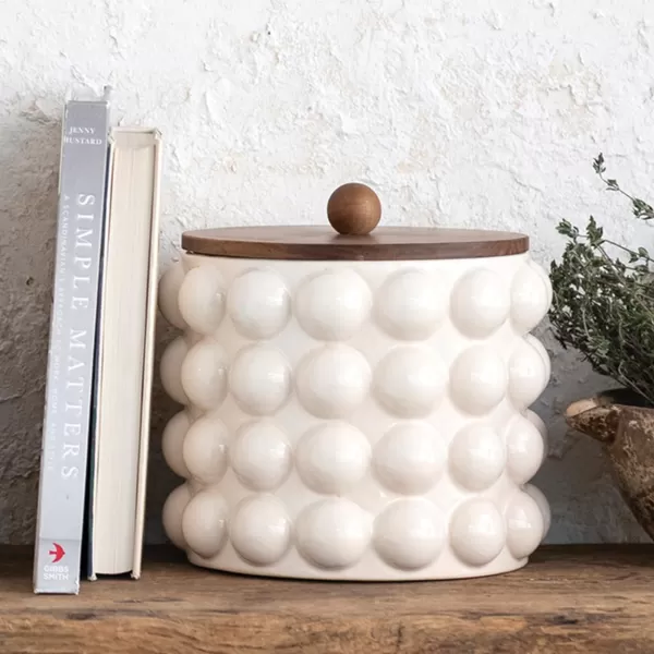 imageCreative CoOp 825 Inches Round Stoneware Raised Dots and Acacia Wood Lid White and Natural Canister