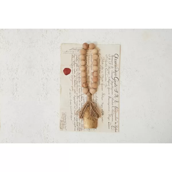 imageCreative CoOp Metal Bell and Mango Wood Bead Door Hanger with Jute Fringe Antique Gold Finish Natural