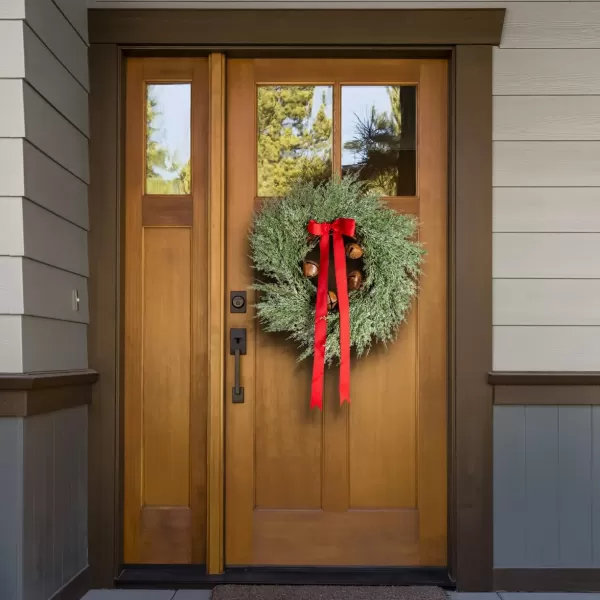 imageCreative CoOp Round Faux Wreath with Red Ribbon and Rust Finish Metal Bells