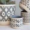 imageCreative CoOp Modern Stoneware Planters with HandPainted Geometric Designs Set of 4 Sizes Black and Natural