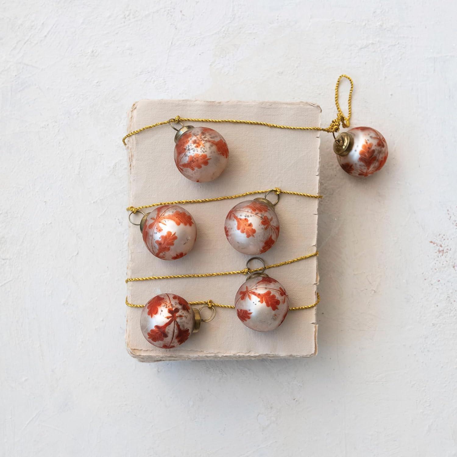 imageCreative CoOp Etched Mercury Glass Ball Ornament Garland with Gold Cord Matte Silver Finish and Coral Color