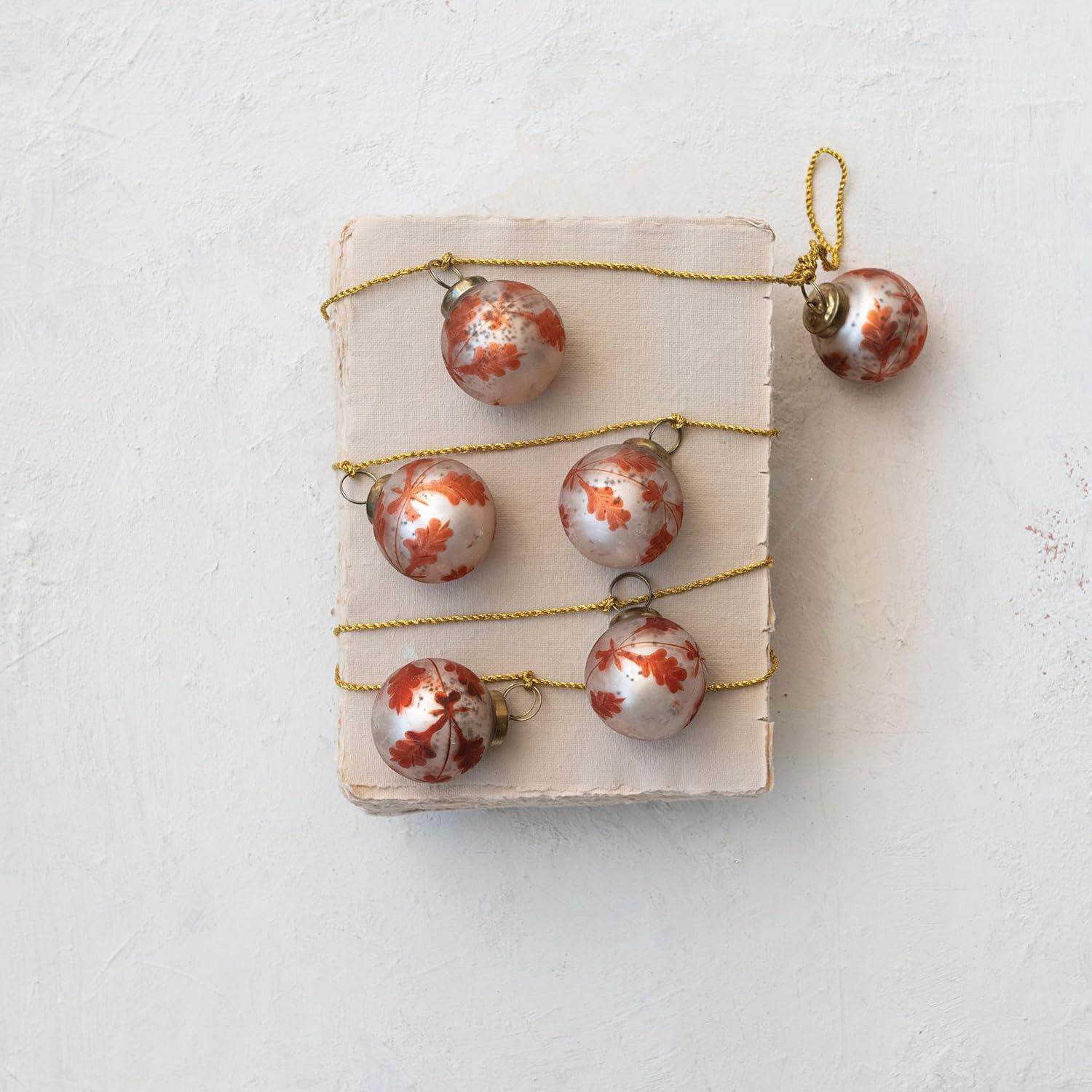 imageCreative CoOp Etched Mercury Glass Ball Ornament Garland with Gold Cord Matte Silver Finish and Coral Color