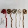 imageCreative CoOp Handmade Wool Felt Ball Garland in Printed Drawstring Bag Brown and Cream Color