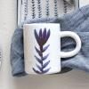 imageCreative CoOp Bloomingville Creative CoOp Hand Painted Stoneware Mug with Flower Design Antique Blue and White Reactive Glaze Set of 4 5quot L x 3quot W x 4quot H DF6578SETMug