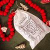 imageCreative CoOp Decorative Handmade Wool Felt Ball Garland in Printed Drawstring Bag Red