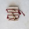 imageCreative CoOp Metal Bell Garland with Painted Pattern and Cotton Tassels Gold Finish Red and White