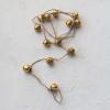 imageCreative CoOp Handmade Metal Bell Garland on Jute Rope Gold Finish