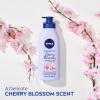 imageNIVEA Oil Infused Cherry Blossom and Jojoba Oil Body Lotion NonGreasy Cherry Blossom Scented Lotion Moisturizes for 24 Hours 169 Fl Oz Pump BottleCherry Blossom