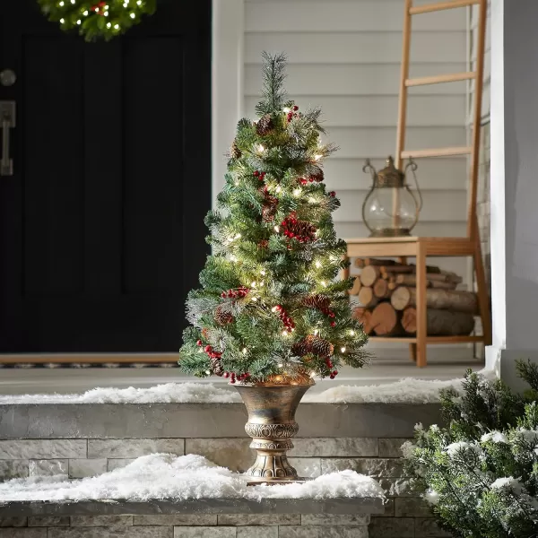 imageNational Tree Company PreLit Artificial Mini Christmas Tree Green Crestwood Spruce White Lights Decorated with Pine Cones Berry Clusters Frosted Branches Includes Pot Base 4 Feet4 ft