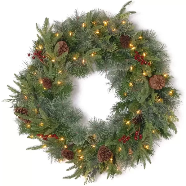 imageNational Tree Company PreLit Artificial Christmas Wreath Green Colonial Fir White Lights Decorated with Pine Cones Berry Clusters Christmas Collection 24 Inches